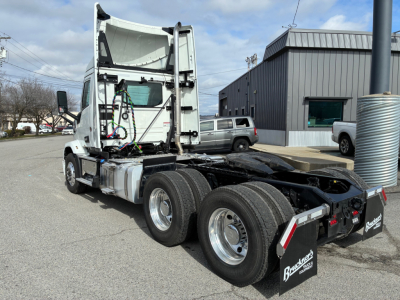 Truck cab and chassis of a Mack AN64T tractor showing rear view with dual rear axles and exposed wiring near the sleeper area.