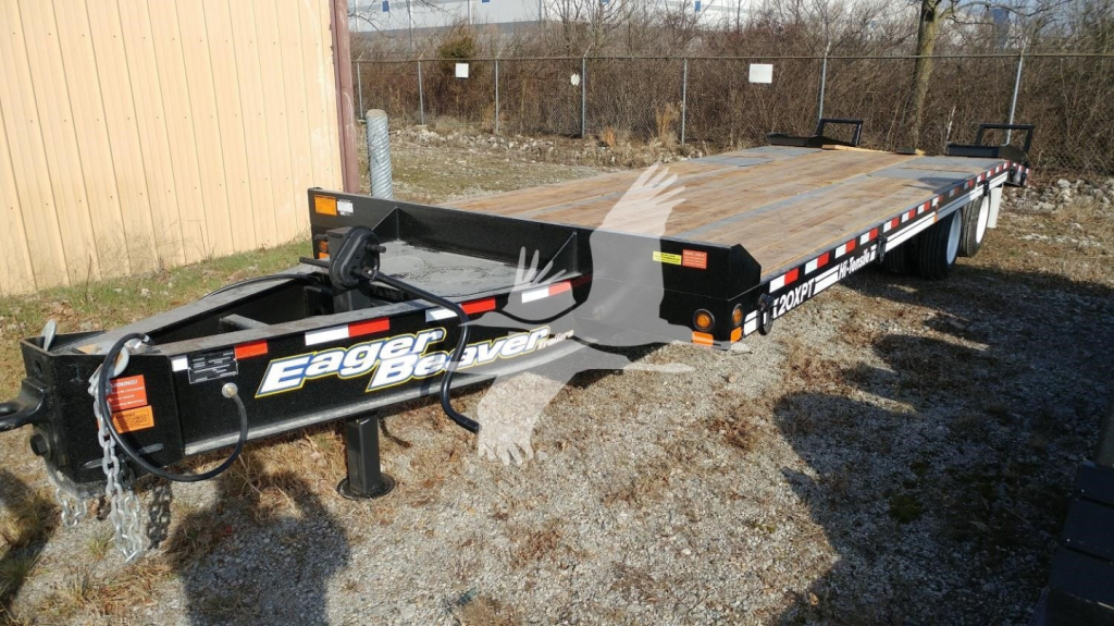 Trailer showing Eager Beaver brand on hitch area and long flatbed with wooden deck.