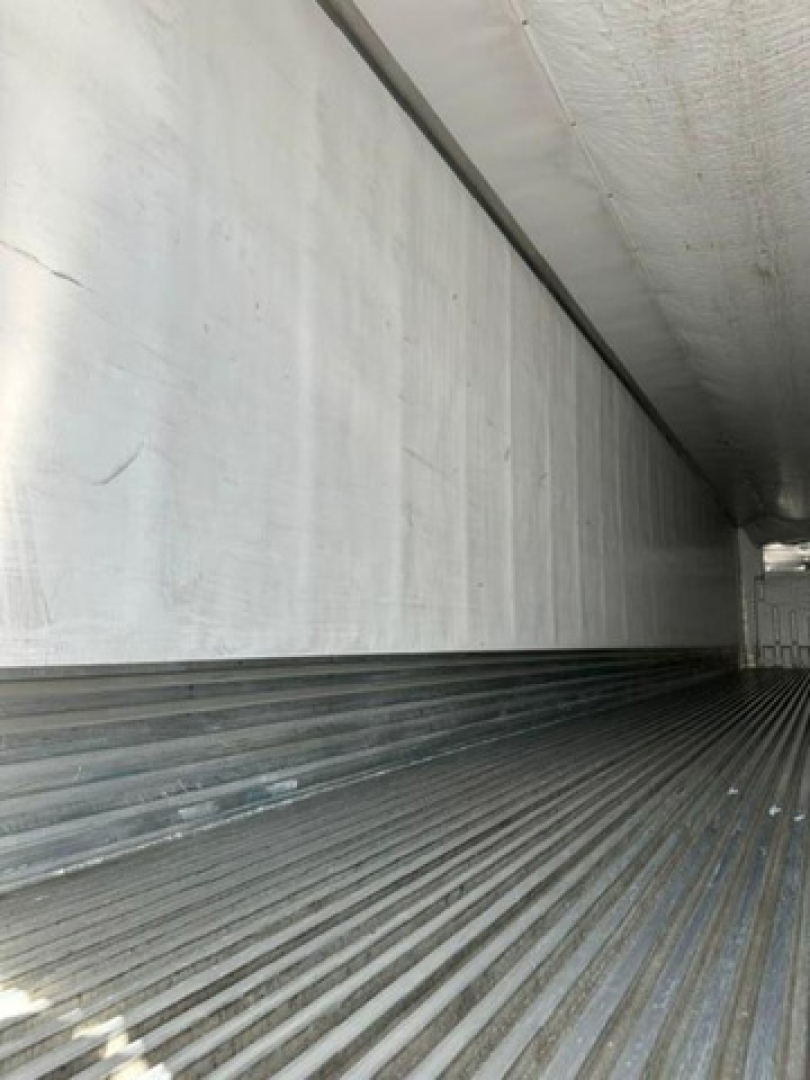 Refrigerated trailer interior showing ribbed metal floor and insulated sidewall in a used 2016 utility reefer.