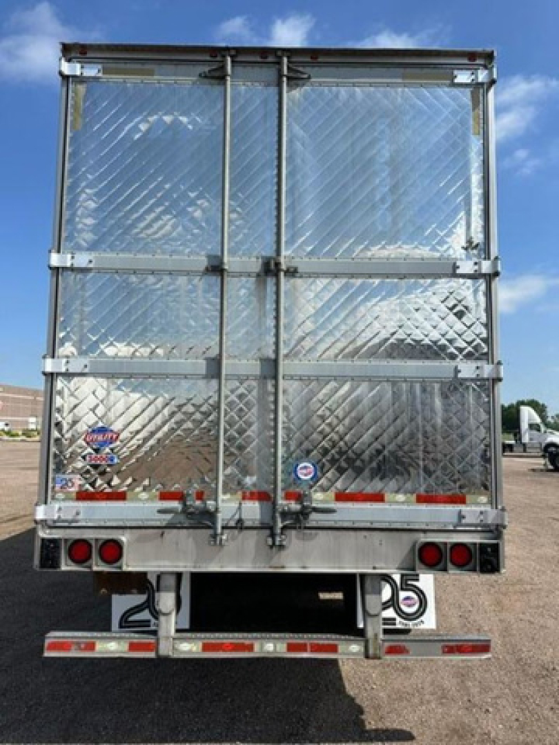 Rear view of a diamond-plate insulated refrigerated trailer with double doors, metal latches, and reflectors.