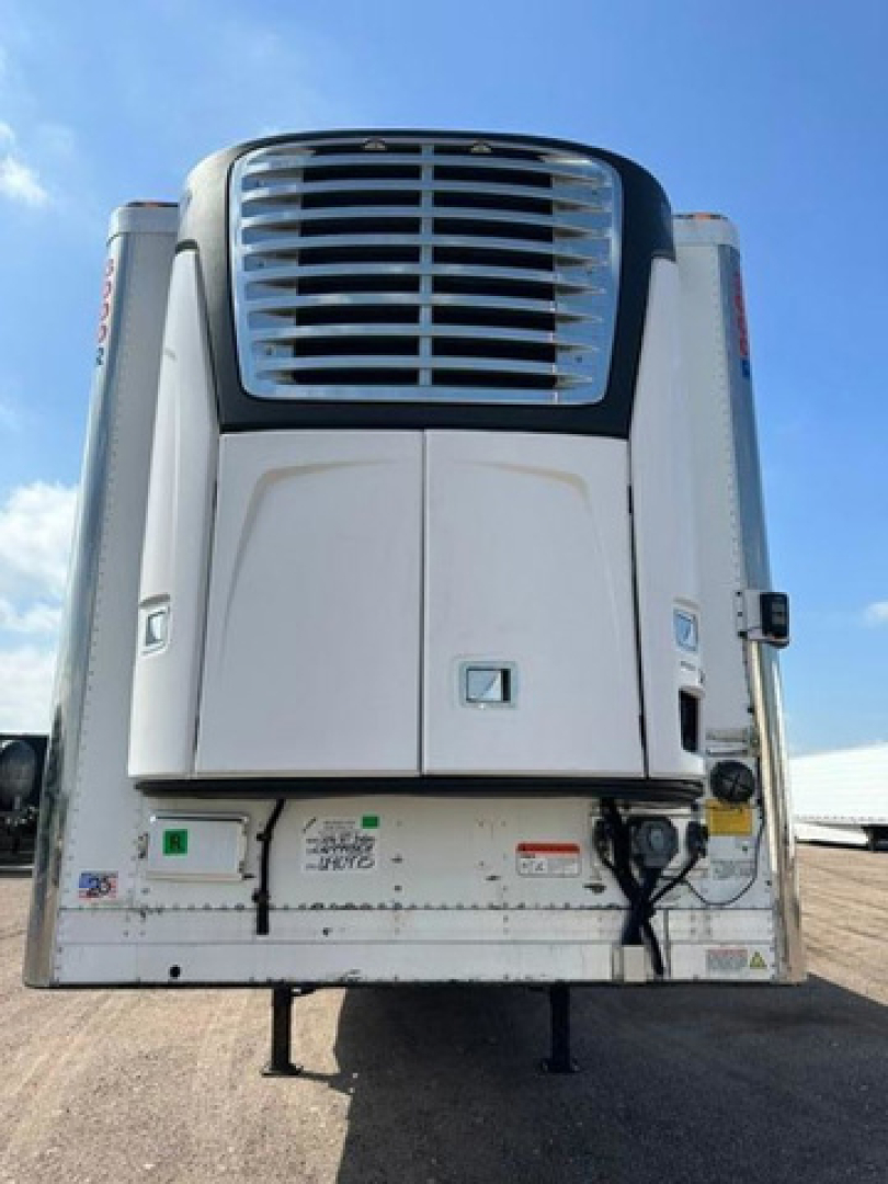Refrigerated trailer rear showing cooling unit, doors, and bumper with stock decals.