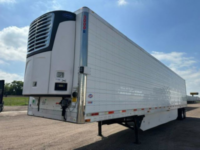 Trailer refrigeration unit on a 2016 Utility reefer trailer showing a blue and white Thermo King or similar refrigerator unit at the front with a vertical door/side rails, trailer body with white insulated panels, undercarriage and landing 