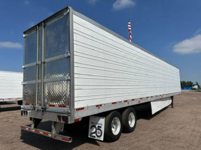 Trailer side and rear showing a white refrigerated trailer with metal diamond plate rear doors and tandem axles.