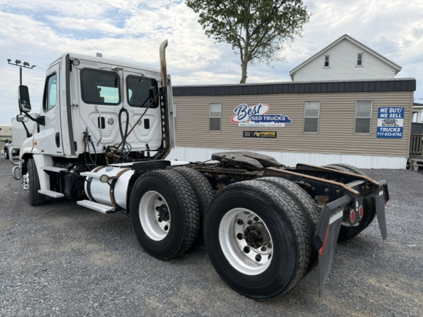 Truck chassis view of a 2017 Freightliner Cascadia CA125DC with dual rear axles and exposed cab, fuel tanks, and exhaust stack.