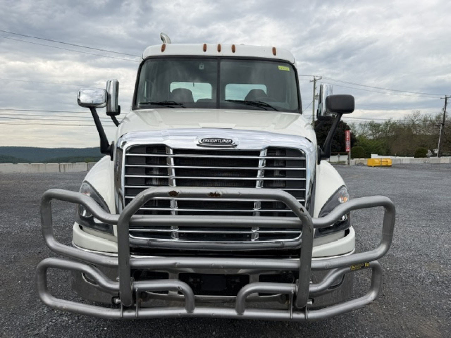 Front view of a 2017 Freightliner Cascadia CA125DC conventional daycab truck with a heavy-duty grille guard.