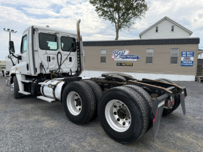 Truck chassis view of a 2017 Freightliner Cascadia CA125DC with dual rear axles and exposed cab, fuel tanks, and exhaust stack.