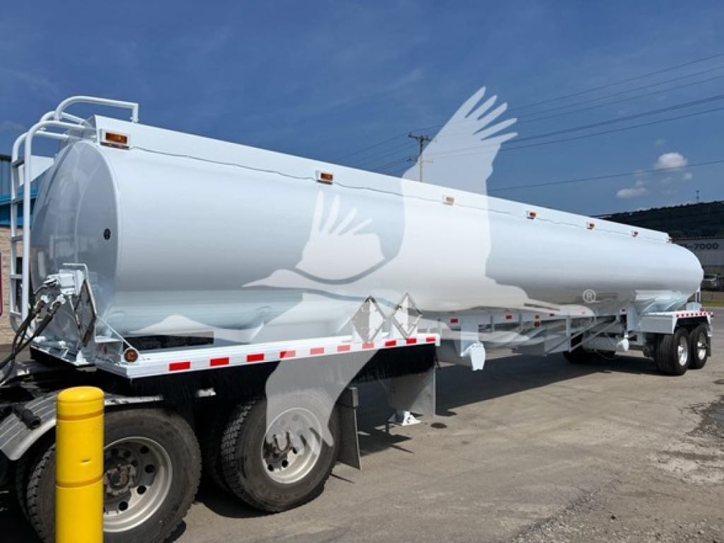 Tank trailer showing a large white Heil petroleum tanker mounted on a multi-axle trailer.