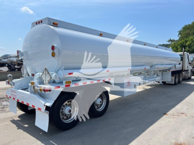 Tank trailer showing cylindrical Heil petroleum fuel tank with rear view, twin-axle wheels, safety reflectors, and rear lights.