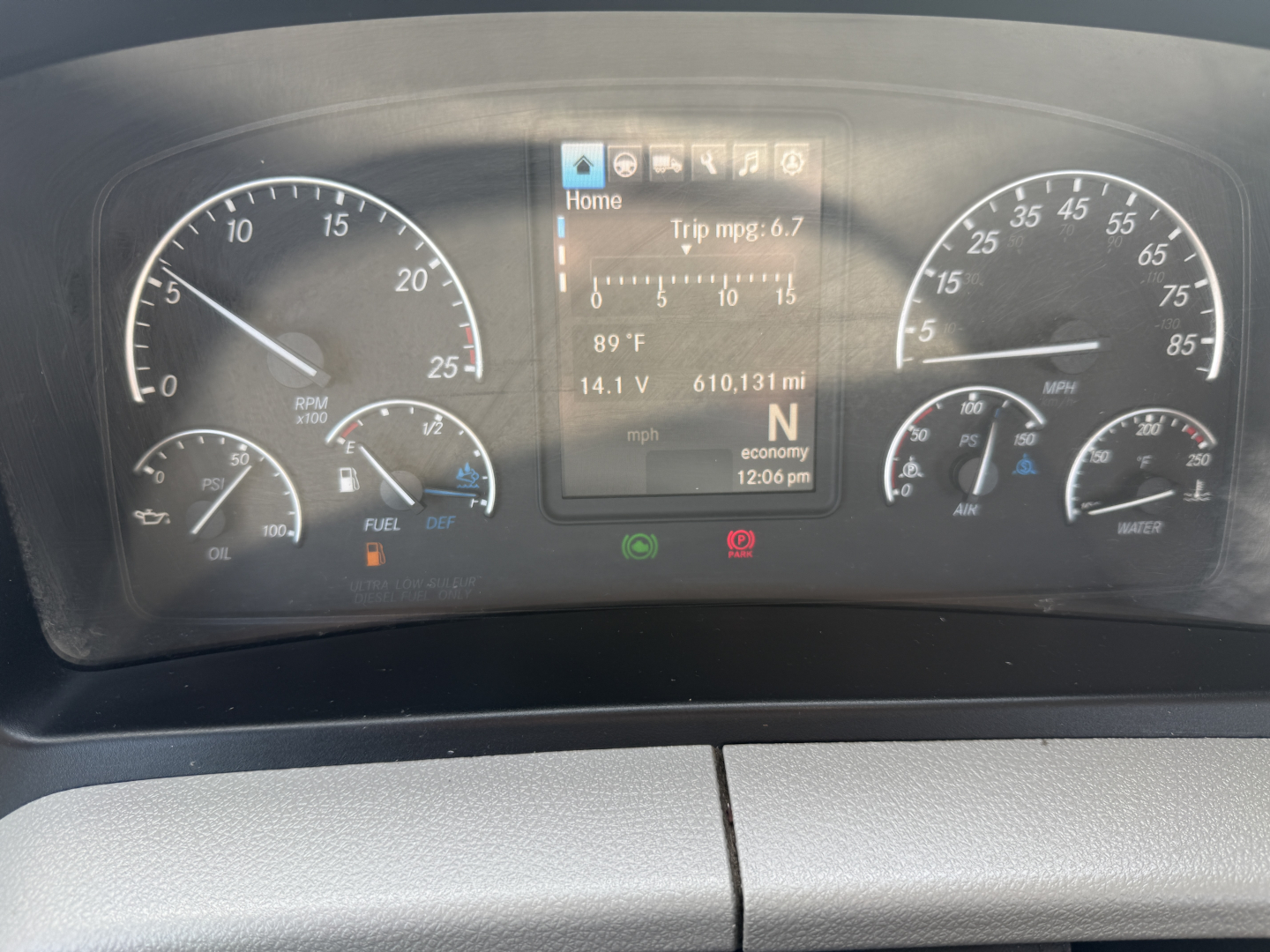 Dashboard of a Freightliner PT126064S T showing speedometer, tachometer, fuel gauge, engine indicators, and a central display with trip information.