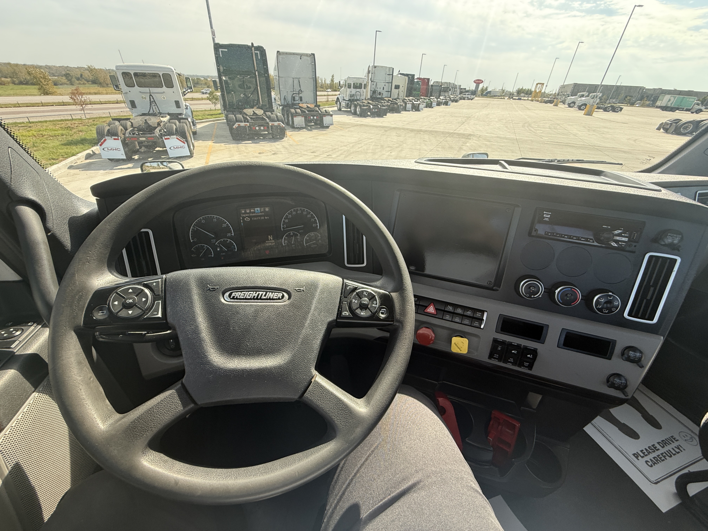Freightliner PT126064S T cabin interior showing steering wheel, dashboard, and control panel with multiple gauges and switches.