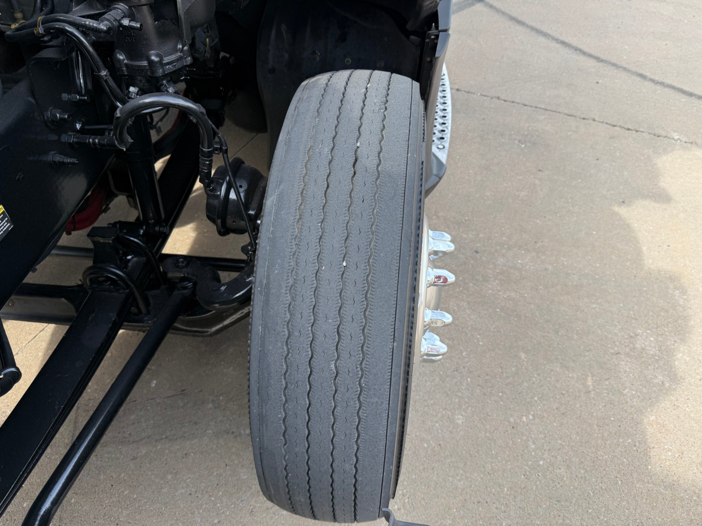 Kenworth T680 front wheel and suspension components inview showing tire and axle area