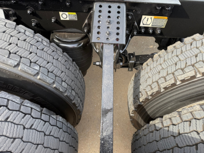 Kenworth T680 chassis area showing dual rear axles with tires and chassis crossmember.