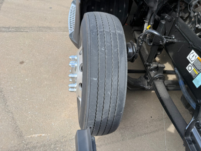 Kenworth T680 front wheel and suspension view showing tire and axle components
