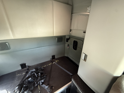 Kenworth T680 sleeper cab interior showing cargo area and side paneling.