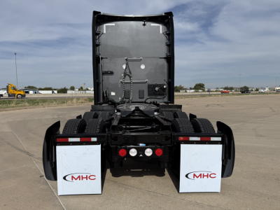 Kenworth truck rear view showing fifth wheel and mud flaps with MHC logos.
