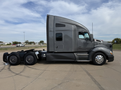 Kenworth T680 side view showing sleeper cab, rear wheels, and exterior panels.