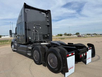 Kenworth T680 truck tractor rear view showing dual rear axles and mudflaps with MHC branding.