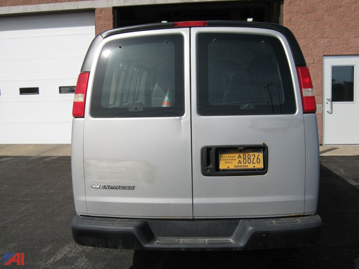 Chevrolet Express 1500 cargo van rear view showing double doors, yellow license plate, and tail lights.