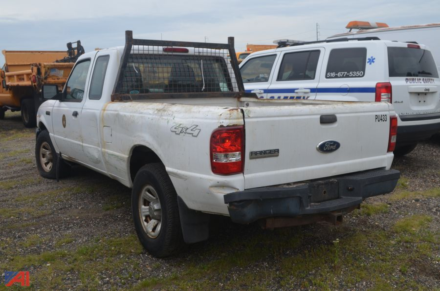 Ford Ranger pickup truck utility rear view showing 4x4 badge and utility rack in bed.
