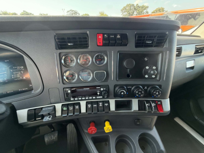 Kenworth T680 truck dashboard interior showing gauges, controls, and knobs with red hazard switch; cup holders visible; VIN and stock info in listing, not on image.