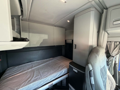 Kenworth T680 sleeper cab interior showing bunk bed and storage compartments
