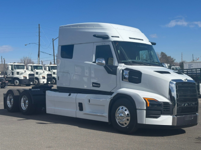 Mack PR64T76M truck cab with sleeper in white, side view showing front grille and wheels.