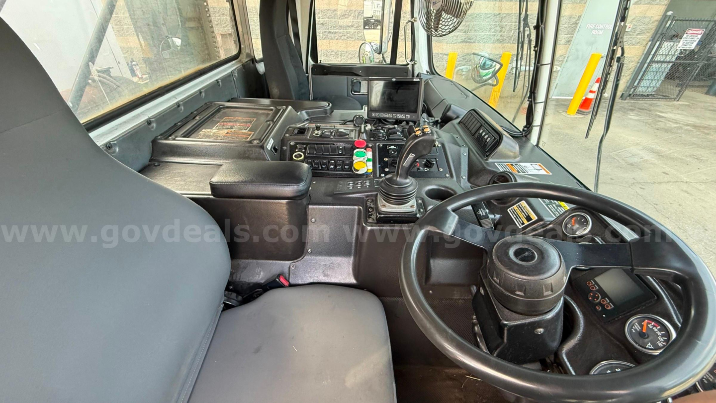 Cab interior of 2016 Autocar Xpeditor showing steering wheel, dashboard, and control panel with gear lever and gauges.