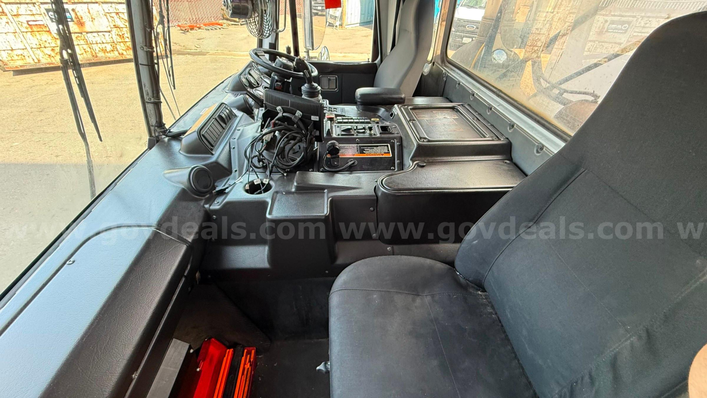 Cockpit of 2016 Autocar Xpeditor showing operator controls, steering column, and instrument console.