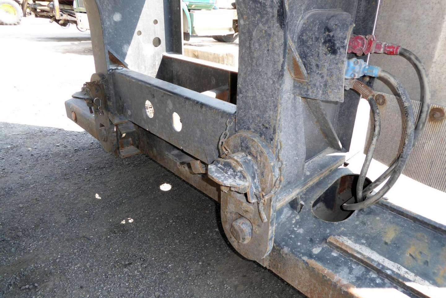 Fontaine trailer hitch mechanism showing heavy steel linkage and hydraulic hose connections.