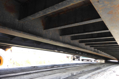 Underbody view of a Fontaine 302WDMR-LT trailer frame showing crossmembers and steel beams.