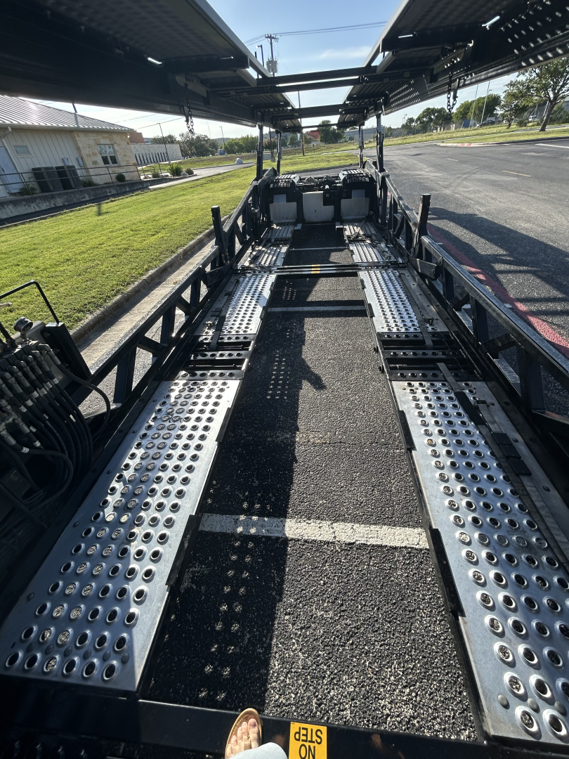 Car carrier trailer chassis with perforated steel deck and multiple bays, interior view of the loading platform for CX-5308LT showing cross beams and wheel wells.