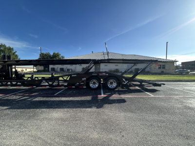Trailer showing lowboy car carrier with dual axles and ramps, side view.