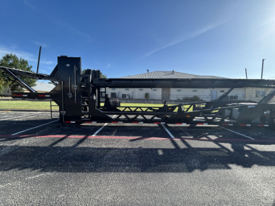 Trailer chassis of a 2022 Cottrell CX-5308LT car carrier trailer showing side profile with hydraulic equipment and lattice frame.