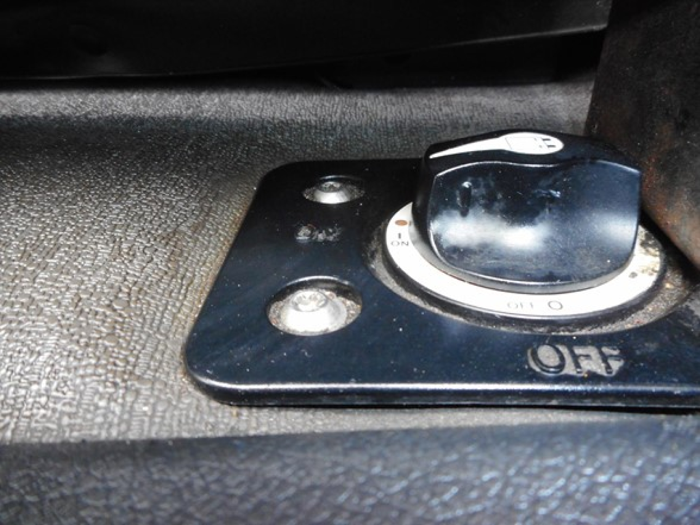 Tractor-trailer cab fuel cap and control panel view showing a circular dial labeled OFF on the Freightliner Cascadia dash area.