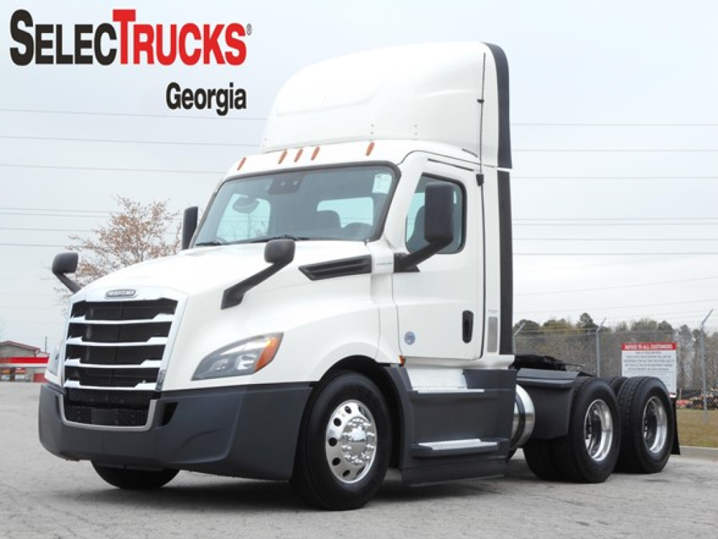 Freightliner Cascadia 126 day cab truck in showroom lot showing SelecTrucks Georgia logo