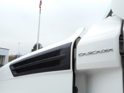 Freightliner Cascadia 126 side cab badge and vent area visible