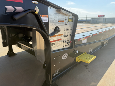 Landoll 455B-53 55 Ton traveling axle lowboy trailer rear control panel with labels and yellow entry step visible.
