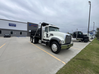 2020 Mack GR64F dump truck in a dealership lot showing cab and front grille with Mack logo.
