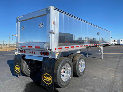 Mac Western lightweight trailer rear view showing dual rear axles with polished chrome wheels, aluminum bulkhead, and MAC Trailer mudflaps.