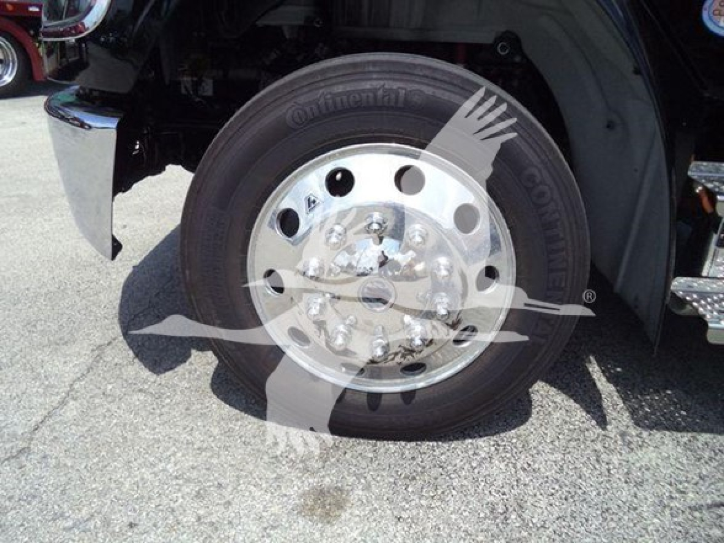 Truck wheel close-up showing Continental tire and polished aluminum hub with lug nuts