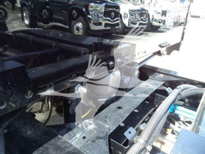 Freightliner M2 chassis rails and hydraulic lines with metallic components and bolts visible