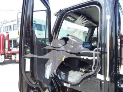 Freightliner M2 106 Plus truck cab interior and open door showing dashboard and seating.