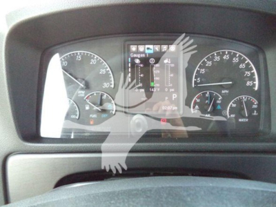 Dashboard view of a 2027 Freightliner M2 106 Plus showing gauges and digital cluster with controls in center console.