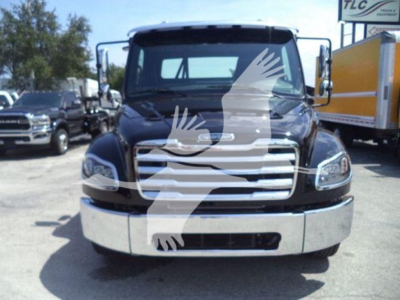 Front view of a Freightliner M2 106 Plus rollback truck showing chrome grille and bumper with black body and clear headlights.