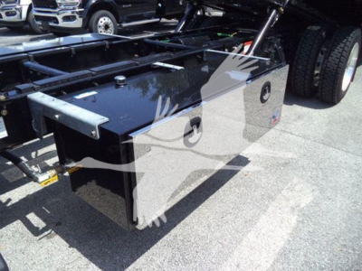 Freightliner M2 106 Plus rollback truck chassis showing a glossy storage toolbox with rounded corners and two circular access ports.