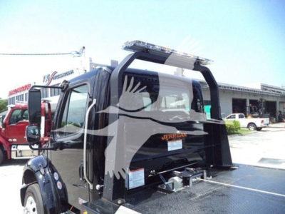 Freightliner M2 106 Plus rollback truck rear view showing hydraulic tow setup and rear cab window, black paint.