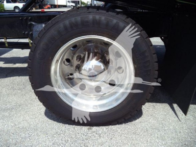 Freightliner M2 106 Plus rollback truck wheel showing Goodyear tire and polished steel rim.