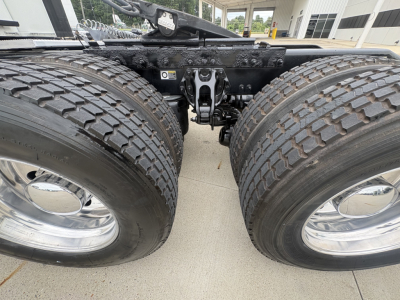 Peterbilt 579 tractor rear dual wheels and fifth wheel hitch undercarriage showing dual tires and suspension components.