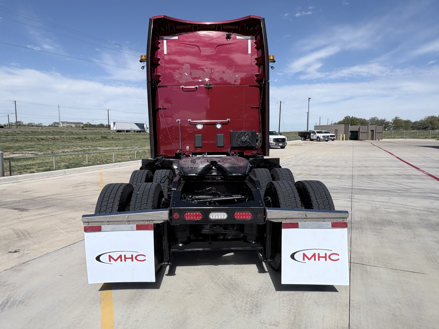 Peterbilt 579 tractor rear view showing chassis and mud flaps with MHC logo