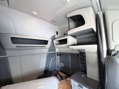 Peterbilt 579 truck interior cab area with overhead storage and instrument panels. No. visible text other than brand logos.